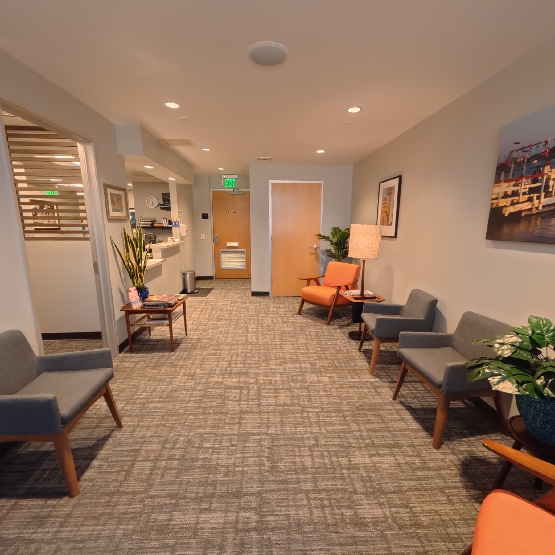 Patient waiting area with comfortable seating and local artwork