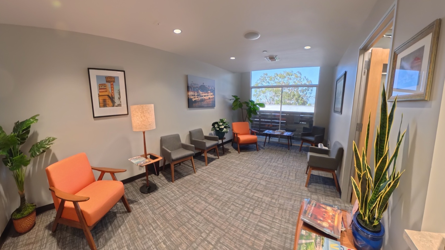 Bright waiting room with seating, plants, and a large window