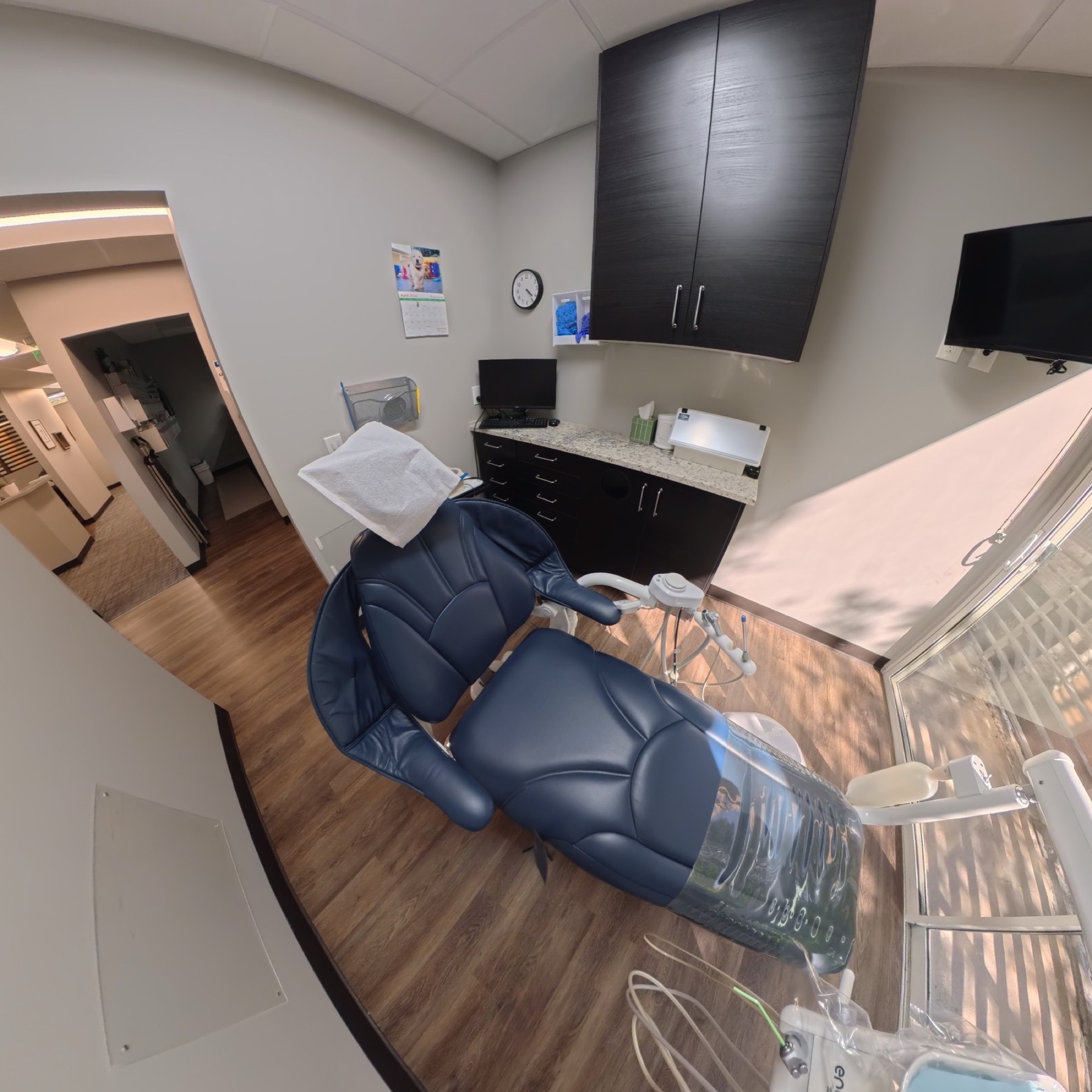 Clean private dental treatment room with modern cabinetry